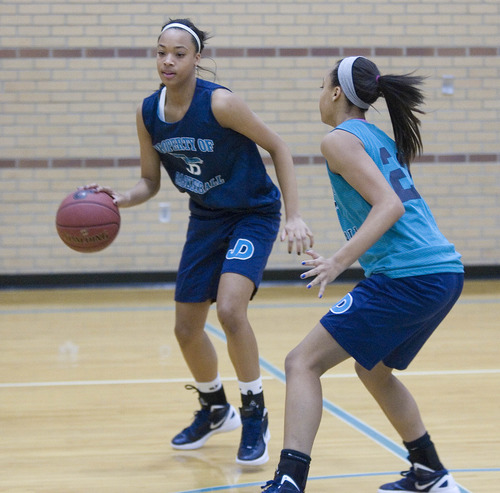 Paul Fraughton | The Salt Lake Tribune.
Twin sisters Dominigue, right,  and Monique  Mills work on practice drills in the Juan Diego gym.
 Monday, February 6, 2012