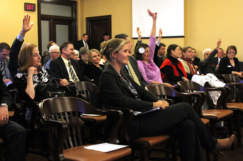 Francisco Kjolseth  |  The Salt Lake Tribune
Amanda Smith, center, executive director of the Utah Department of Environmental Quality is surrounded by raised hands hoping to speak in opposition to SB21, creating revisions to environment boards dealing with clean air, water, radioactive waste and other matters.