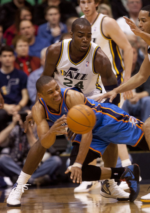 Trent Nelson  |  The Salt Lake Tribune
Oklahoma City Thunder guard Russell Westbrook (0) passes the ball out of the double team by Utah Jazz forward Paul Millsap (24) and guard Devin Harris (5) as the Utah Jazz host the Oklahoma City Thunder, NBA basketball at EnergySolutions Arena Friday, February 10, 2012 in Salt Lake City, Utah.