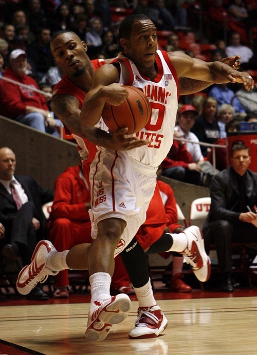 Trent Nelson  |  The Salt Lake Tribune
New Mexico's A.J. Hardeman (rear) reaches in on Utah's Chris Hines as Utah defeats New Mexico 82-72 in college basketball action Wednesday, January 19, 2011.