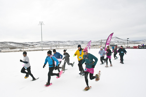 Chris Detrick  |  The Salt Lake Tribune
Participants race during the Tubbs Romp to Stomp Out Breast Cancer Snowshoe Series at the Round Valley Trails at Quinn's Junction Saturday February 11, 2012. The event raises money for the Salt Lake City affiliate of Susan G. Komen for the Cure.