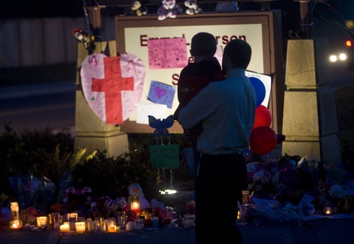 Al Hartmann  |  The Salt Lake Tribune
Father and son pay their respects at a candle memorial at the Emma Carson Elementary School in Puyallup, Washington Monday February 6 for Charles and Braden Powell.