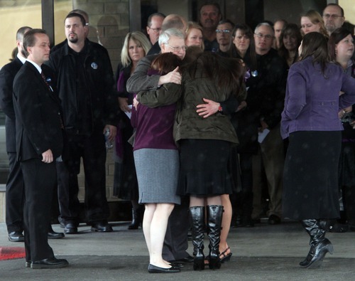 Rick Egan  | The Salt Lake Tribune 
Chuck Cox and other family members join in a group hug after the funeral for Charlie and Braden Powell in Tacoma Saturday.