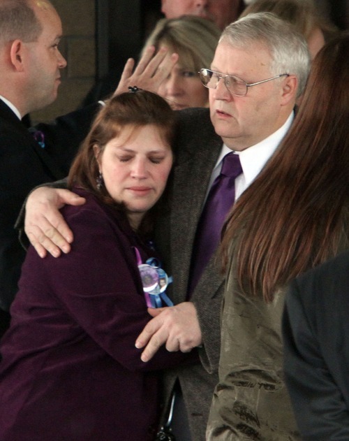 Rick Egan  | The Salt Lake Tribune 
Denise Cox hugs her father, Chuck Cox, after the funeral for Charlie and Braden Powell at the Life Center Church in Tacoma Saturday.