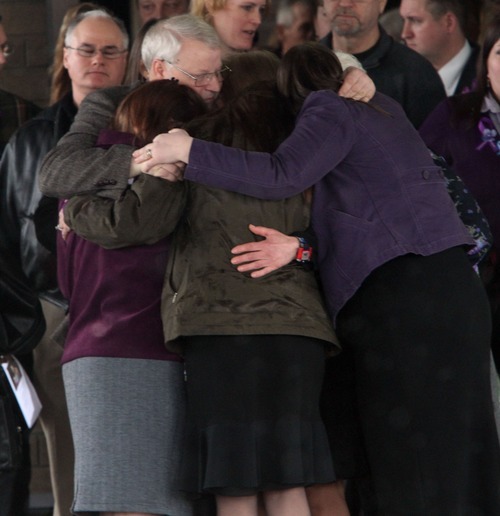 Rick Egan  | The Salt Lake Tribune 
Chuck Cox and other family members join in a group hug after the funeral for Charlie and Braden Powell at the Life Center Church in Tacoma Saturday.