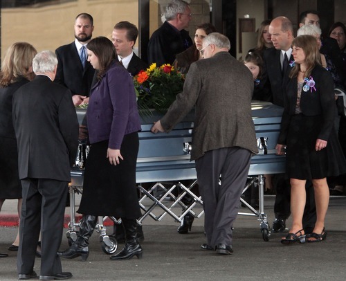 Rick Egan  | The Salt Lake Tribune 
Chuck Cox and his daughters wheel out the casket after the funeral for Charlie and Braden Powell at the Life Center Church in Tacoma, Saturday.