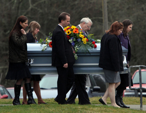 Rick Egan  |  The Salt Lake Tribune 
Chuck Cox and other family members and friends carry the casket after the services in Puyallup for Charlie and Braden Powell Saturday.