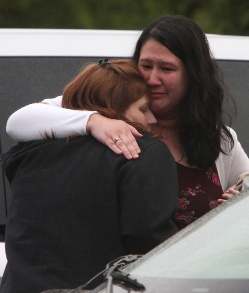 Rick Egan  | The Salt Lake Tribune 
Denise Cox, left, sister of Susan Cox Powell, gets a hug from a friend after leaving services for Charlie and Braden Powell in Puyallup, Wash., Saturday.