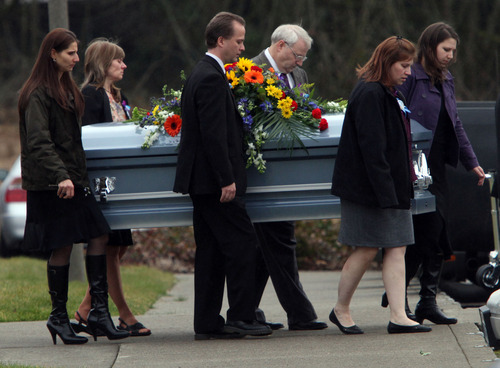 Rick Egan  |  The Salt Lake Tribune 
Chuck Cox and other family members and friends carry the casket of Charlie and Braden Powell after the services in Puyallup on Saturday.