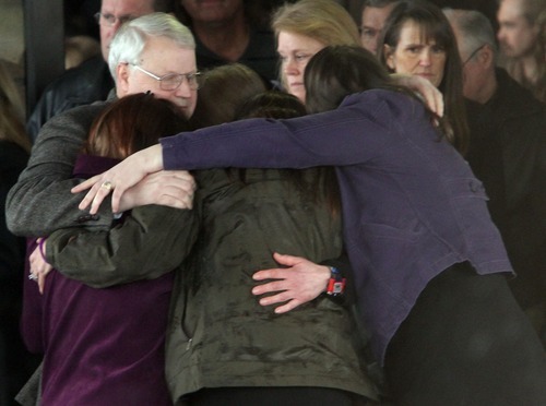 Rick Egan  | The Salt Lake Tribune 
Chuck Cox and other family members join in a group hug after the funeral for Charlie and Braden Powell at the Life Center Church in Tacoma.