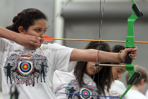 Francisco Kjolseth  |  The Salt Lake Tribune
Nicole Granados, 12, of Lakeridge Jr. High sights her target during the Utah State National Archery in the Schools Tournament. The tournament run by the Utah Division of Wildlife, took place at The Salt Palace Convention Center on Saturday, February 11, 2012, as part of the Western Hunting and Conservation Expo.