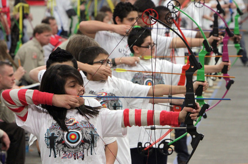 Francisco Kjolseth  |  The Salt Lake Tribune
Elaine Granados, 12, of Lakeridge Jr. High lines up her shot during the Utah State National Archery in the Schools Tournament. The tournament run by the Utah Division of Wildlife, took place at The Salt Palace Convention Center on Saturday as part of the Western Hunting and Conservation Expo.