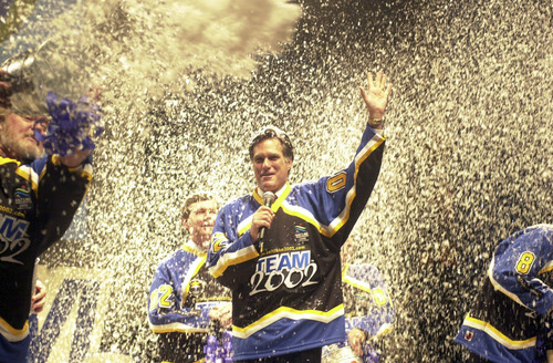 Tribune file photo
Mitt Romney waves after being blasted with fake snow at the kickoff of a SLOC volunteer drive in March 2000. The event at Abravanel Hall featured ski racer Picabo Street, former NFL quarterback and volunteer leader Steve Young and Utah Gov. Mike Leavitt.