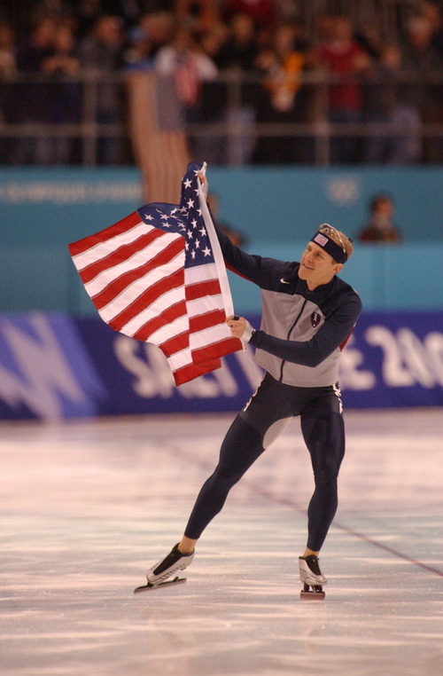 Danny La | Tribune file photo
Speedskater Casey Fitzrandolph of the United States skates a victory lap with the American flag after winning the men's 500 meters at the Utah Olympic Oval.