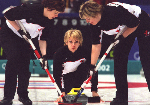 Grayson West | Tribune file photo
Canada's Diane Nelson delivers a stone during a curling match against the United States at the Ogden Ice Sheet.