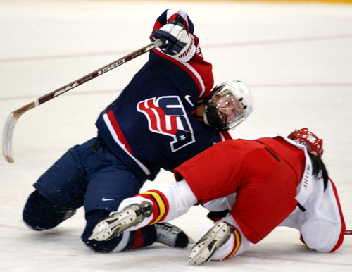 Danny La | Tribune file photo
Jenny Potter of the United States collides with China's Jin Fengling during a 12-0 victory for the Americans in a women's preliminary-round women's hockey game at the Peaks Ice Arena in Provo.