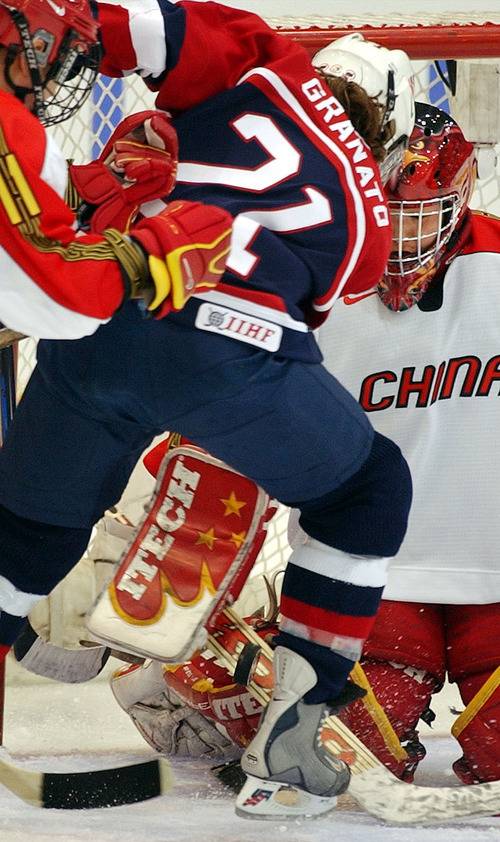 Danny La | Tribune file photo
Cammi Granato of the United States tries to get the puck past goaltender Guo Hong and teammate Hu Chunrong of China in a preliminary-round game the Americans won 12-0 at the Peaks Ice Arena in Provo.