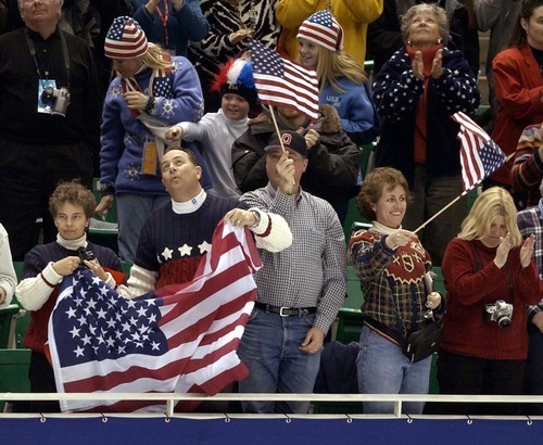 Trent Nelson | Tribune file photo
Fans wave flags and cheer for American figure skater Todd Eldredge during the men's free skate at the Delta Center.