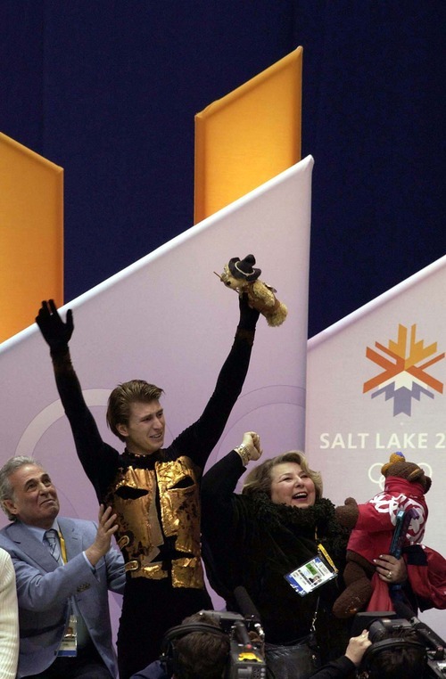 Trent Nelson | Tribune file photo
Figure skater Alexei Yagudin of Russia, his coach and others celebrate after seeing the scores that confirm Yagudin has won the men's figure skating gold medal at the Delta Center.