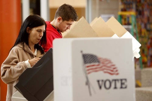 Tribune File Photo
A new study says Utah voter rolls are full of invalid registrations -- either because of deaths, changes of residence or bad addresses.
 This file photo from November shows Lori and Bryce Williams casting ballots in the recent Salt Lake City municipal election.