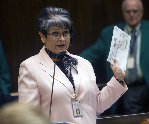 Al Hartmann  |  The Salt Lake Tribune
Rep. Merlynn Newbold, R-South Jordan, holds up a voter registration letter she received for her deceased father of 18 months on the floor of the Utah House. She discussed the letter in the context of HB105, which would allow purging bad names on voter lists.