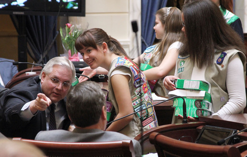 Francisco Kjolseth  |  The Salt Lake Tribune
Alissa Snyder, 14, a member of the Girl ?Scouts is encouraged by Sen. Stuart Reid, R-Ogden, to deliver some cookies to Senate President Michael Waddoups, R-Taylorsville, and Sen. Peter Knudson, R-Brigham City, on Wednesday. A concurrent resolution was presented to both the House and Senate on Wednesday to recognize the 100th anniversary of the Girl Scouts.