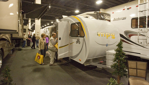 Paul Fraughton  |  The Salt Lake Tribune
People step inside a small trailer on display at the annual Utah Sportsmen's Vacation and RV Show at the South Towne Expo Center on Thursday. The MPG trailer was surrounded by trailers and  motor homes of every category and price point at the show, which will run through Sunday.