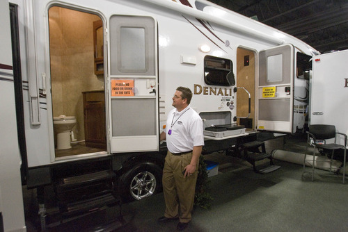 Paul Fraughton  |  The Salt Lake Tribune
Mike Hodson, of Sierra RV, shows off a bathroom that opens from the outside as well as the inside of a trailer at the annual Utah Sportsmen's Vacation and RV Show. Some RVs at the show featured exterior TVs, cook stoves and refrigerators, as well as covered patios.