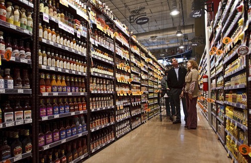 Leah Hogsten  |  The Salt Lake Tribune
Stephanie Jordan and Randy Frisk, vendors from Sacramento, Calif., peruse the BBQ sauce aisle. The new Harmons grocery opened Wednesday in downtown Salt Lake City. The store at 100 S. 135 East was built on two levels. A 50,000-square-foot ground level features a large produce department and meat counter with fresh fish. On the 18,000-square-foot mezzanine there is a deli with a seating capacity for about 300 customers.