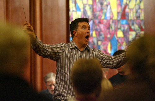 Steve Griffin  |  The Salt Lake Tribune

Conductor Brady Allred leads the Salt Lake Choral Artists as they perform the Bluegrass Mass during rehearsal at the First Baptist Church sanctuary.