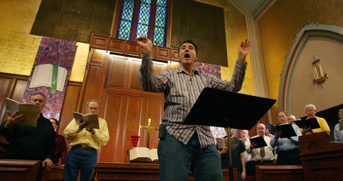 Steve Griffin  |  The Salt Lake Tribune

Conductor Brady Allred leads the Salt Lake Choral Artists as they perform the Bluegrass Mass during rehearsal at the First Baptist Church sanctuary.
