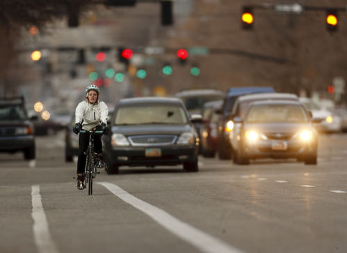 Trent Nelson  |  The Salt Lake Tribune
Cyclists riding along 300 East during afternoon traffic Thursday, February 2, 2012 in Salt Lake City, Utah. Salt Lake City has received a $25,000 grant for an experimental bike lane configuration where parked cars would provide a protected bike lane (which would be closest to the curb). The project will start on 300 East between 600 and 900 South.