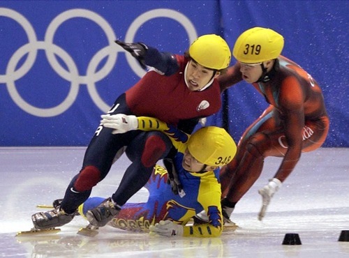 Steve Griffin | Tribune file photo
Korea's Hyun-soo Ahn crashes into American short-track speedskater Apolo Anton Ohno in the final turn of the men's 1,000 meters, taking Canada's Mathieu Turcotte with him and clearing the way for Australian Steven Bradbury to come from far behind and win gold at the Delta Center.