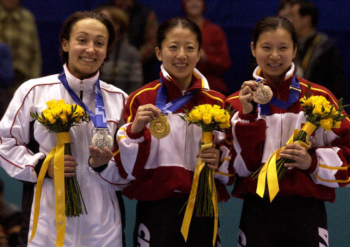 Leah Hogsten | Tribune file photo
Silver medalist Evgenia Radanova of Bulgaria, left, joins gold medalist Yang Yang (A) of China and bronze medalist Wang Chunlu of China at the medal ceremony following the women's 500-meter short-track race at the Delta Center.