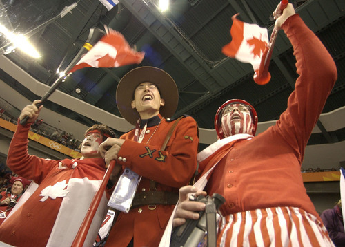 Ryan Galbraith | Tribune file photo
Canadian fans cheer their team as it plays to a 3-3 tie with the Czech Republic in the preliminary round of the men's hockey tournament -- squeaking into the quarterfinals amid much criticism and second-guessing.