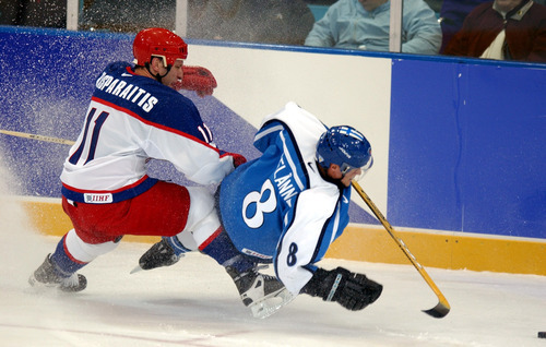 Danny La | Tribune file photo
Russia's Darius Kasparaitis trips up Finland's Teemu Selanne during a preliminary-round men's hockey game at the Peaks Ice Arena in Provo. Finland won 3-1, after scoring three unanswered goals.