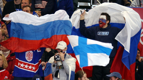 Danny La | Tribune file photo
Russian and Finnish fans wave flags during the preliminary-round men's hockey game between their countries at the Peaks Ice Arena in Provo.
