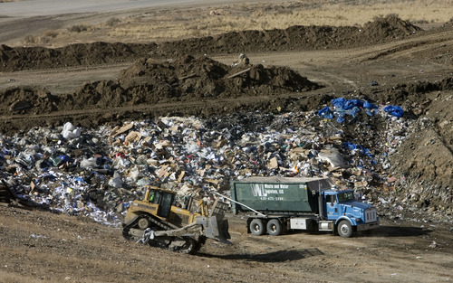 Al Hartmann  |  The Salt Lake Tribune
Garbage truck with municipal waste dumps its garbage in a tiny portion in the massive landfill near East Carbon.   ECDC Environmental wants to be permitted to bury PCB waste in a small section in of one of the super cells at the landfill.