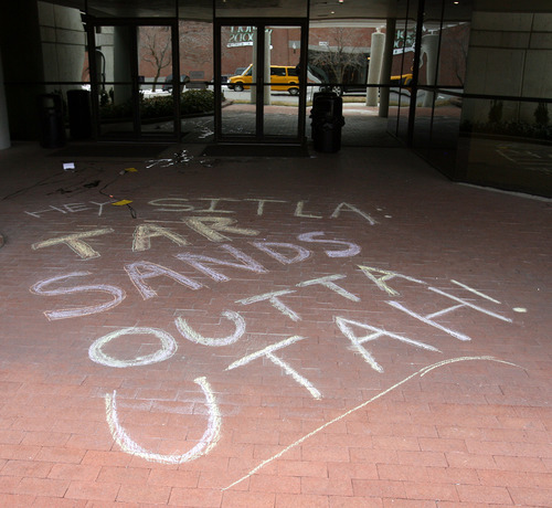 Steve Griffin  |  The Salt Lake Tribune

Chalk messages are drawn at the entrance to the Utah Trust Lands Administration offices in Salt Lake City on Monday, Feb. 20, 2012, as members of the environmental group Earth First! protest the development of tar sands in the Book Cliffs area of Utah.