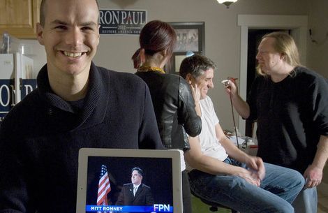 Paul Fraughton  |  The Salt Lake Tribune.
Jeffrey Harmon is one of the founders of Utah-based Endorse Liberty, a super PAC campaigning for Republican presidential hopeful Ron Paul. Harmon, a 29-year-old Provo resident, shows off one of the satirical videos his group has produced. In the background is Nate Jones, who plays the fake Mitt Romney, being made up by Chris Richard Hanson, right, and Danielle Donahue.