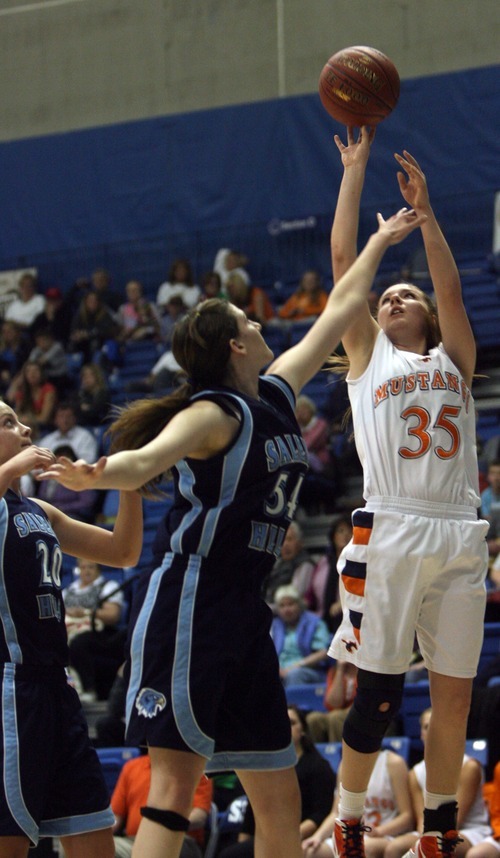 Kim Raff  |  The Salt Lake Tribune
Mountain Crest player Kenzie Rasmussen takes a shot as she is defended by Salem Hills player (left) Lyssa Hanks during the 4A girls Quarterfinals at Salt Lake Community College in Taylorsville , Utah on February 22, 2012. Mountain Crest went on to win the game 61-45.