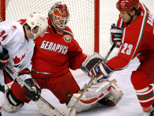 Danny La | Tribune file photo
Goaltender Andrei Mezin and Ruslan Salei of Belarus try to keep Canada's Ryan Smith, left, from scoring in Canada's 7-1 semifinal victory at the E Center in West Valley City. The Canadians booked a date with the United States in the gold-medal game.