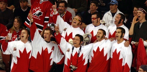 Danny La | Tribune file photo
Canadian fans celebrate their team beating Belarus 7-1 in the men's hockey semifinals at the E Center in West Valley City, to earn a shot at breaking a 50-year gold-medal drought against the United States in the final.