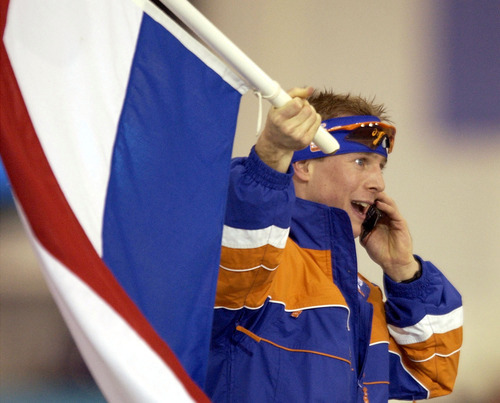 Steve Griffin | Tribune file photo
Speedskater Jochem Uytdehaage of the Netherlands talks on the phone after winning the men's 10,000 meters at the Utah Olympic Oval in world-record time. It's his second gold medal of the Games, in addition to a silver.