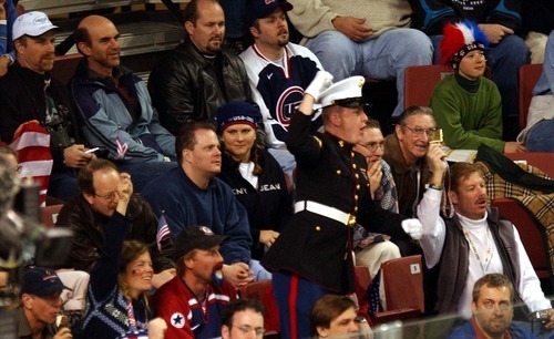 Danny La | Tribune file photo
A man in a U.S. Marine uniform tries to inspire other fans to chant 
