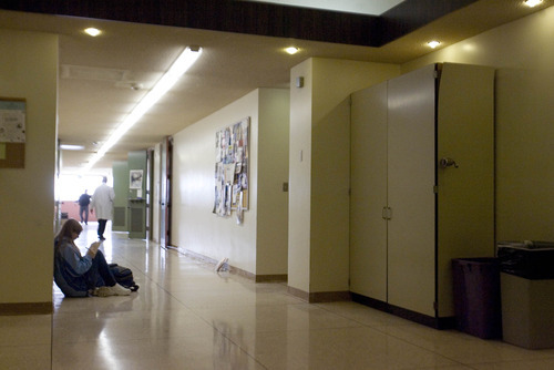 Paul Fraughton | The Salt Lake Tribune.
A student sits in a hallway of  Weber State University's science building. With few places for students to gather outside the classroom the hallway floor is the only option.