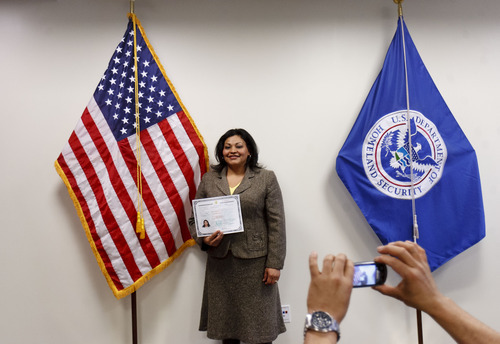Trent Nelson  |  The Salt Lake Tribune
New U.S. citizen Rosa Singuenza poses for a photo after a naturalization ceremony at the new Salt Lake City office of the U.S. Citizenship and Services District on Thursday, Feb. 23, 2012. USCIS held a grand opening celebration of its new Salt Lake office, and the naturalization ceremony where ten new citizens were naturalized.