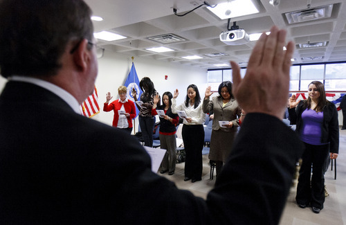 Trent Nelson  |  The Salt Lake Tribune 
U.S. Citizenship and Services District Director Robert Mather swore in 10 new U.S. citizens at the new USCIS office in Salt Lake City office of the U.S. Citizenship and Services District on Thursday, Feb. 23, 2012. USCIS held a grand opening celebration of its new Salt Lake City office, and the naturalization ceremony where ten new citizens were naturalized.