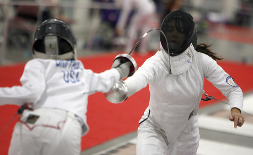 Francisco Kjolseth  |  The Salt Lake Tribune
Olivia Briffault, 16, left, of New York lunges at Christina Nakajima, 15, of Atlanta, in their bout during the Junior Olympic Fencing competition at the Salt Palace Convention Center on Saturday.