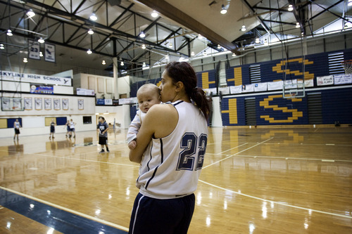 Kim Raff |The Salt Lake Tribune
Ta'a Tuinei holds her infant son Tereinga Tuinei while during practice at Skyline High School in Salt Lake City, Utah on February 9, 2012.